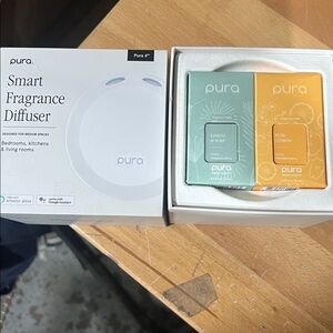 Pura Smart Fragrance Diffuser with 2 scent refills.